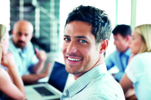 Portrait of a handsome bsuinessman at a meeting along with his colleague at back in office